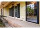 Covered front entrance with brick detail, black shutters, and a black-trimmed glass front door at 2343 Kings Point Dr, Dunwoody, GA 30338