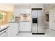 Updated kitchen with stainless steel refrigerator and tiled floors at 2343 Kings Point Dr, Dunwoody, GA 30338