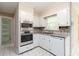 Well-lit kitchen with stainless steel appliances and bright white cabinetry at 2343 Kings Point Dr, Dunwoody, GA 30338