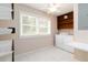 Bright laundry room with washer, dryer, shelving, tiled floor, and natural light at 2343 Kings Point Dr, Dunwoody, GA 30338