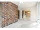 Cozy living room featuring a brick wall and open access to other rooms at 2343 Kings Point Dr, Dunwoody, GA 30338