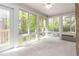 Bright sunroom with large windows offering views of the surrounding trees at 2343 Kings Point Dr, Dunwoody, GA 30338