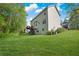 View of the home's exterior showcasing a spacious, well-maintained backyard with lush greenery and access stairs at 2979 Sweetbriar Walk, Snellville, GA 30039