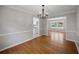 Charming dining room with hardwood floors, classic chandelier, and seamless transition into other spaces at 2979 Sweetbriar Walk, Snellville, GA 30039