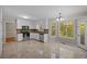 Kitchen features white cabinets, stainless steel appliances, granite counters, tile flooring, and a window view at 2979 Sweetbriar Walk, Snellville, GA 30039