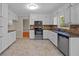 Bright kitchen featuring white cabinets, stainless steel appliances, granite counters and tile backsplash at 2979 Sweetbriar Walk, Snellville, GA 30039