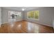 Living room showcasing hardwood floors, large windows, and an open view to the updated kitchen at 2979 Sweetbriar Walk, Snellville, GA 30039
