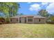 Large backyard with mature trees, an open lawn and a beautiful view of the house at 4960 Shannon Sw Way, Mableton, GA 30126