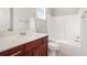 Bathroom with white countertop, wood vanity, toilet, and shower-tub combo with chrome hardware at 4960 Shannon Sw Way, Mableton, GA 30126