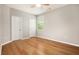 Neutral bedroom featuring hardwood floors, a ceiling fan, and natural light from the window at 4960 Shannon Sw Way, Mableton, GA 30126