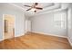 Primary bedroom with a ceiling fan and hardwood floors next to a bathroom and a closet at 4960 Shannon Sw Way, Mableton, GA 30126