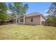 Rear exterior view of the home highlighting the windows and back patio area at 4960 Shannon Sw Way, Mableton, GA 30126