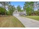Spacious home with well-maintained lawn, long driveway, attached garage, and a classic American flag at 4960 Shannon Sw Way, Mableton, GA 30126