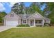 Charming single-story home featuring a manicured lawn, attached garage, and covered front porch at 4960 Shannon Sw Way, Mableton, GA 30126