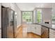 Open kitchen with stainless steel fridge and granite countertop connects to the living room at 4960 Shannon Sw Way, Mableton, GA 30126