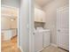 Laundry room with white appliances and convenient storage cabinets at 4960 Shannon Sw Way, Mableton, GA 30126