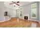 Spacious living room with a fireplace, hardwood floors, open to the kitchen area and filled with natural light at 4960 Shannon Sw Way, Mableton, GA 30126