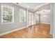 A bright, airy living room with hardwood floors, large windows, and elegant lighting at 4960 Shannon Sw Way, Mableton, GA 30126