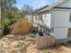 View of a fenced-in backyard with an outdoor seating area, grill, and lush green trees at 1041 Cherryfield Run, Marietta, GA 30008
