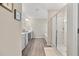 Elegant bathroom with double vanities, glass shower, and wood-look flooring at 1041 Cherryfield Run, Marietta, GA 30008