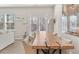 Bright dining area features a long, unique wooden table with seating for ten and views to the backyard at 1041 Cherryfield Run, Marietta, GA 30008