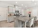 Stylish kitchen features gray cabinets, granite countertops, stainless steel appliances, and a large island at 1041 Cherryfield Run, Marietta, GA 30008