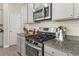 Modern kitchen featuring stainless steel appliances, granite countertops, and stylish cabinetry with plenty of storage at 1041 Cherryfield Run, Marietta, GA 30008