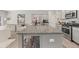 Open-concept kitchen featuring a large island with seating, stainless steel appliances, and hardwood floors at 1041 Cherryfield Run, Marietta, GA 30008