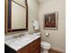 Elegant powder room featuring marble countertop, stylish mirror, and classic fixtures at 1061 Arbor Ne Trce, Atlanta, GA 30319
