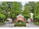 Gated community entrance with brick gatehouse, landscaping, and elegant signage at 1061 Arbor Ne Trce, Atlanta, GA 30319