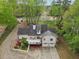 An aerial view of the home showing its black roof, deck, landscaping, and two car garage at 2972 Nw Stilesboro Nw Rd, Kennesaw, GA 30152