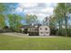 Large backyard showcasing the house with the multi-level backyard with a spacious driveway at 2972 Nw Stilesboro Nw Rd, Kennesaw, GA 30152