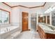 Bathroom with double vanity, stand alone shower, and soaking tub at 2972 Nw Stilesboro Nw Rd, Kennesaw, GA 30152