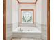 Bathroom showcasing soaking tub beneath decorative stained glass window at 2972 Nw Stilesboro Nw Rd, Kennesaw, GA 30152