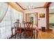 Sunny dining area featuring a chandelier, hardwood floors, and glass doors leading to another room at 2972 Nw Stilesboro Nw Rd, Kennesaw, GA 30152