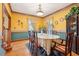 Bright dining room featuring hardwood floors, unique wall décor, and a built-in china cabinet at 2972 Nw Stilesboro Nw Rd, Kennesaw, GA 30152