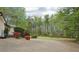 Long paved driveway with garden and lawn leads up to the beautiful house surrounded by trees at 2972 Nw Stilesboro Nw Rd, Kennesaw, GA 30152