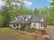 Attractive home with a covered porch, dormer windows, and beautifully landscaped front yard at 2972 Nw Stilesboro Nw Rd, Kennesaw, GA 30152
