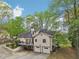 Back view of home featuring a raised wooden deck, a basketball hoop, and two-car garage at 2972 Nw Stilesboro Nw Rd, Kennesaw, GA 30152