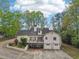 View of the home's backyard featuring a deck, two car garage, and lush greenery at 2972 Nw Stilesboro Nw Rd, Kennesaw, GA 30152