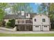 Back of the house featuring a deck on the second story and garage access on ground level at 2972 Nw Stilesboro Nw Rd, Kennesaw, GA 30152