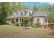 Charming home exterior with a full front porch, dormer windows, and a well-maintained lawn at 2972 Nw Stilesboro Nw Rd, Kennesaw, GA 30152