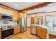 Bright kitchen featuring stainless steel appliances, wooden cabinets, and a view to dining area at 2972 Nw Stilesboro Nw Rd, Kennesaw, GA 30152