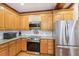 Functional kitchen with stainless steel appliances, granite countertops, and wooden cabinetry at 2972 Nw Stilesboro Nw Rd, Kennesaw, GA 30152
