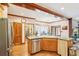 Open-concept kitchen with hardwood floors, stainless steel appliances, and access to dining room at 2972 Nw Stilesboro Nw Rd, Kennesaw, GA 30152