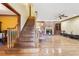 Open-concept living room with hardwood floors, brick fireplace, and staircase at 2972 Nw Stilesboro Nw Rd, Kennesaw, GA 30152