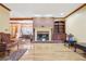 Bright living room featuring a brick fireplace, hardwood floors, and comfortable furnishings at 2972 Nw Stilesboro Nw Rd, Kennesaw, GA 30152