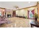 Sun-filled living room showcasing a fireplace, built-in shelves, and beautiful hardwood floors at 2972 Nw Stilesboro Nw Rd, Kennesaw, GA 30152