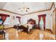 Spacious main bedroom featuring hardwood floors, tray ceilings, and ample natural light at 2972 Nw Stilesboro Nw Rd, Kennesaw, GA 30152