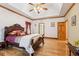 Main bedroom features hardwood floors, tray ceiling, and a large wood-framed bed at 2972 Nw Stilesboro Nw Rd, Kennesaw, GA 30152